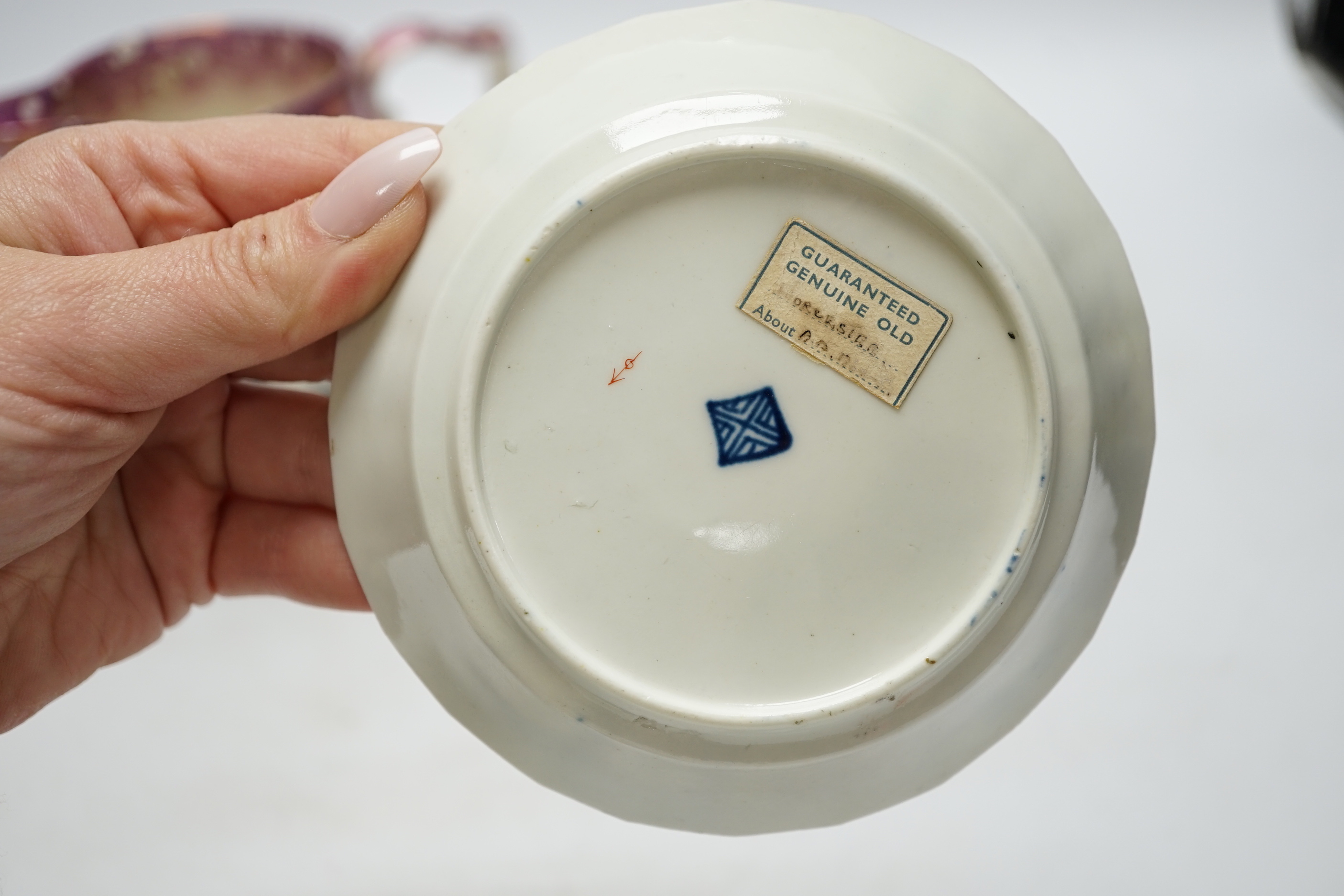 A Worcester Kakiemon pattern coffee cup and saucer, c.1780 and Gray’s Pottery pink lustre ‘’Iron Bridge Sunderland’’ jug, (3), 13cm